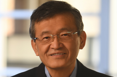 Portrait of Lip-Bu Tan smiling in front of a window